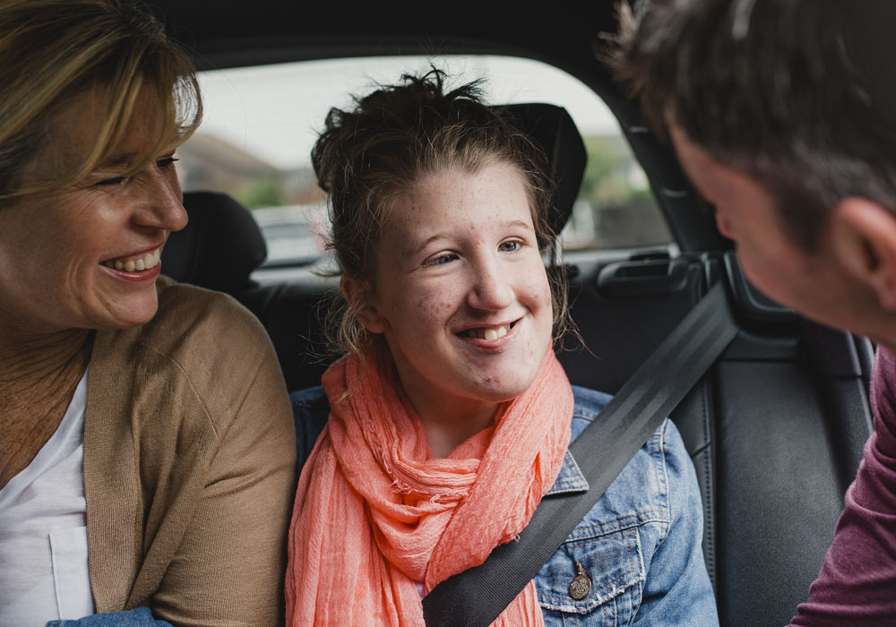 Girl in the car with parents